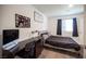 Comfortable bedroom featuring dark floors, a desk area, and bright natural light at 7890 Aurora Sky St # 1, North Las Vegas, NV 89084