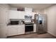 Bright kitchen features stainless steel appliances, granite counters, and ample white cabinets at 7890 Aurora Sky St # 1, North Las Vegas, NV 89084