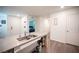 Open kitchen featuring an island with modern countertops and stainless steel sink at 7890 Aurora Sky St # 1, North Las Vegas, NV 89084
