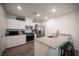 Charming kitchen with stainless steel appliances, granite counters, white cabinets and seating at the breakfast bar at 7890 Aurora Sky St # 1, North Las Vegas, NV 89084