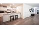Modern kitchen with white cabinets, stainless steel appliances, and counter seating for a delightful culinary space at 7890 Aurora Sky St # 1, North Las Vegas, NV 89084
