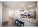 Open kitchen design with breakfast bar and modern appliances perfect for culinary enthusiasts and entertaining guests at 7890 Aurora Sky St # 1, North Las Vegas, NV 89084