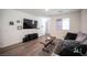 Bright living room showcasing a modern entertainment center and plush seating for relaxation and entertainment at 7890 Aurora Sky St # 1, North Las Vegas, NV 89084