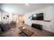 Open-concept living room featuring dining area and entertainment setup with a large TV for versatile living at 7890 Aurora Sky St # 1, North Las Vegas, NV 89084