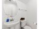 Clean powder room with a pedestal sink, oval mirror, and tiled walls at 8059 Wards Ferry St, Las Vegas, NV 89139