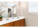 Well-lit bathroom with double sinks, wood cabinets, and a large mirror, creating a functional space at 8059 Wards Ferry St, Las Vegas, NV 89139