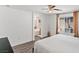 Bedroom with neutral walls and wood floors, featuring archway to bathroom and two bright windows at 8059 Wards Ferry St, Las Vegas, NV 89139