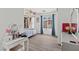 Bedroom with wood floors, white walls, natural light, makeup vanity and desk at 8059 Wards Ferry St, Las Vegas, NV 89139