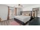 Bedroom featuring a plush bed, a ceiling fan and two windows with natural light at 8059 Wards Ferry St, Las Vegas, NV 89139