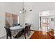 Open dining space featuring a chandelier, wood floors, and large windows with blinds at 8059 Wards Ferry St, Las Vegas, NV 89139
