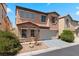 Charming two-story home featuring a terracotta roof, two-car garage and neutral stucco exterior at 8059 Wards Ferry St, Las Vegas, NV 89139