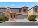 Inviting two-story home displaying a terracotta roof, two-car garage, and warm stucco exterior at 8059 Wards Ferry St, Las Vegas, NV 89139