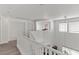 Bright hallway features wood floors, white walls, staircase, and natural light from several windows at 8059 Wards Ferry St, Las Vegas, NV 89139
