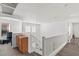 Hallway with wood floors and white walls, with a railing overlooking the lower level and a desk area at 8059 Wards Ferry St, Las Vegas, NV 89139