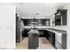 Well-equipped kitchen with stainless steel appliances, dark cabinets, and tile flooring at 8059 Wards Ferry St, Las Vegas, NV 89139