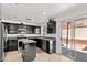 Modern kitchen featuring stainless steel appliances, dark cabinetry, and granite countertops at 8059 Wards Ferry St, Las Vegas, NV 89139