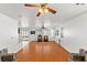 Open living area with hardwood floors, ceiling fans, and sliding glass doors to the backyard at 8059 Wards Ferry St, Las Vegas, NV 89139