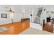 Well-lit living room featuring hardwood floors, a staircase, and access to other rooms at 8059 Wards Ferry St, Las Vegas, NV 89139