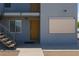 Close-up of apartment entrance featuring a sturdy wooden door, a small awning, and gray exterior paint at 841 A, Boulder City, NV 89005