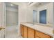 Bathroom boasts wood cabinets, solid countertop and a sink, offering a blend of style and functionality at 8824 Charm Canyon Ave, Las Vegas, NV 89178