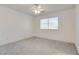 Neutral bedroom with carpet, a ceiling fan, and a bright window at 8824 Charm Canyon Ave, Las Vegas, NV 89178