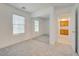 Bright bedroom features neutral carpet, natural light from a large window, and a mirrored closet at 8824 Charm Canyon Ave, Las Vegas, NV 89178