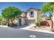Inviting two-story home with mature landscaping, a two-car garage, and a charming facade at 8824 Charm Canyon Ave, Las Vegas, NV 89178