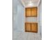 Hallway featuring built-in wood cabinetry for added storage at 8824 Charm Canyon Ave, Las Vegas, NV 89178