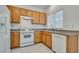 Functional kitchen equipped with white appliances, wood cabinets, and ample counter space at 8824 Charm Canyon Ave, Las Vegas, NV 89178
