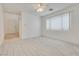 Bright living room boasts wood-look tile floors and neutral paint, illuminated by natural light at 8824 Charm Canyon Ave, Las Vegas, NV 89178