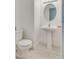 Neat half-bathroom with a pedestal sink, round mirror, and modern fixtures at 8824 Charm Canyon Ave, Las Vegas, NV 89178