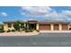 Charming single-story home with a three-car garage, desert landscaping, and a stone entryway at 8985 S Tomsik St, Las Vegas, NV 89113