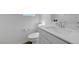 A bathroom with a white sink, cabinets and toilet at 96 Campbelltown Ave, Henderson, NV 89015