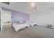Cozy bedroom with two beds and a lovely purple accent wall at 96 Campbelltown Ave, Henderson, NV 89015