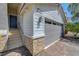Attached two-car garage with brick-paved driveway, stone accents, and a convenient entryway to the home at 96 Campbelltown Ave, Henderson, NV 89015