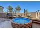 Outdoor space featuring a round above-ground hot tub and a trampoline on sand with two chairs at 96 Campbelltown Ave, Henderson, NV 89015