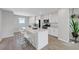 Modern kitchen features an island with seating and granite countertops at 96 Campbelltown Ave, Henderson, NV 89015