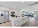 Bright, open kitchen features stainless steel appliances, an island, and white cabinets at 96 Campbelltown Ave, Henderson, NV 89015