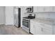 Modern kitchen featuring stainless steel appliances and white cabinets at 96 Campbelltown Ave, Henderson, NV 89015