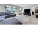 Living room with a large, comfortable grey sofa and lots of light at 96 Campbelltown Ave, Henderson, NV 89015