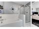 Bathroom featuring white tiled tub, shower, and walls at , Las Vegas, NV 89118