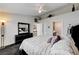 The bedroom boasts neutral walls, carpet, a large mirror dresser, and a ceiling fan at , Las Vegas, NV 89118