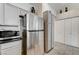 Kitchen featuring stainless steel refrigerator and microwave with ample cabinet space at , Las Vegas, NV 89118