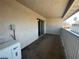 Open-air balcony complete with wall lighting and access to the interior through sliding glass door at 100 S Crestline Dr # 18, Las Vegas, NV 89107