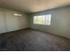 Bedroom features carpet flooring, a modern AC unit, and a bright window at 100 S Crestline Dr # 18, Las Vegas, NV 89107