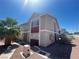 Exterior view of a multi-story residential building with red accent paint, palm tree, and minimal landscaping at 100 S Crestline Dr # 18, Las Vegas, NV 89107