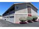Two-story apartment building featuring private garages and upper-level balconies under a clear blue sky at 100 S Crestline Dr # 18, Las Vegas, NV 89107