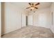 Bedroom featuring neutral walls, carpet flooring, ceiling fan, and two entry doors to other rooms at 10001 Peace Way # 2335, Las Vegas, NV 89147