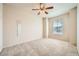 Bright bedroom featuring neutral walls, carpet flooring, ceiling fan, and a window for natural light at 10001 Peace Way # 2335, Las Vegas, NV 89147