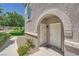 A pair of entry doors behind a stone-look archway at 10001 Peace Way # 2335, Las Vegas, NV 89147